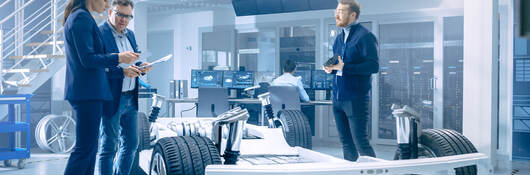 People working around an electric car