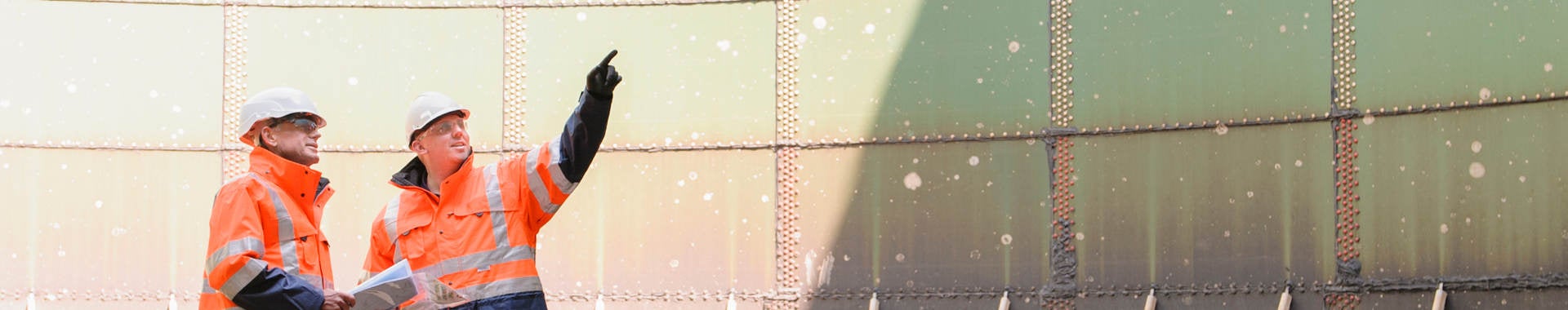 Technicians examining fuel storage tank