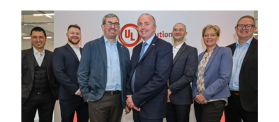 Leadership pictured in front of white wall with UL Solutions logo